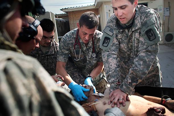 A group of soldiers are performing medical tasks.