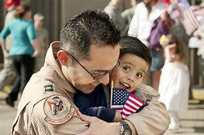 A man holding a child with an american flag.